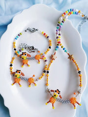Colorful beaded necklaces with dog charms on a white shell