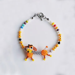 Colorful beaded bracelet with a dog-shaped charm on a white background