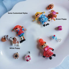 Colorful beaded dog figurines on a white plate with labels for styles. - Verhalo custom jewelry