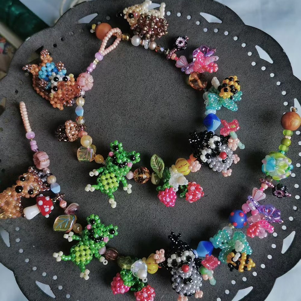 Colorful beaded fairytale garden bracelts on a dark surface - Verhalo Custom Jewelry
