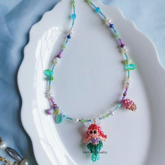 Colorful beaded necklace with a mermaid pendant on a white plate丨Verhalo Custom Jewelry