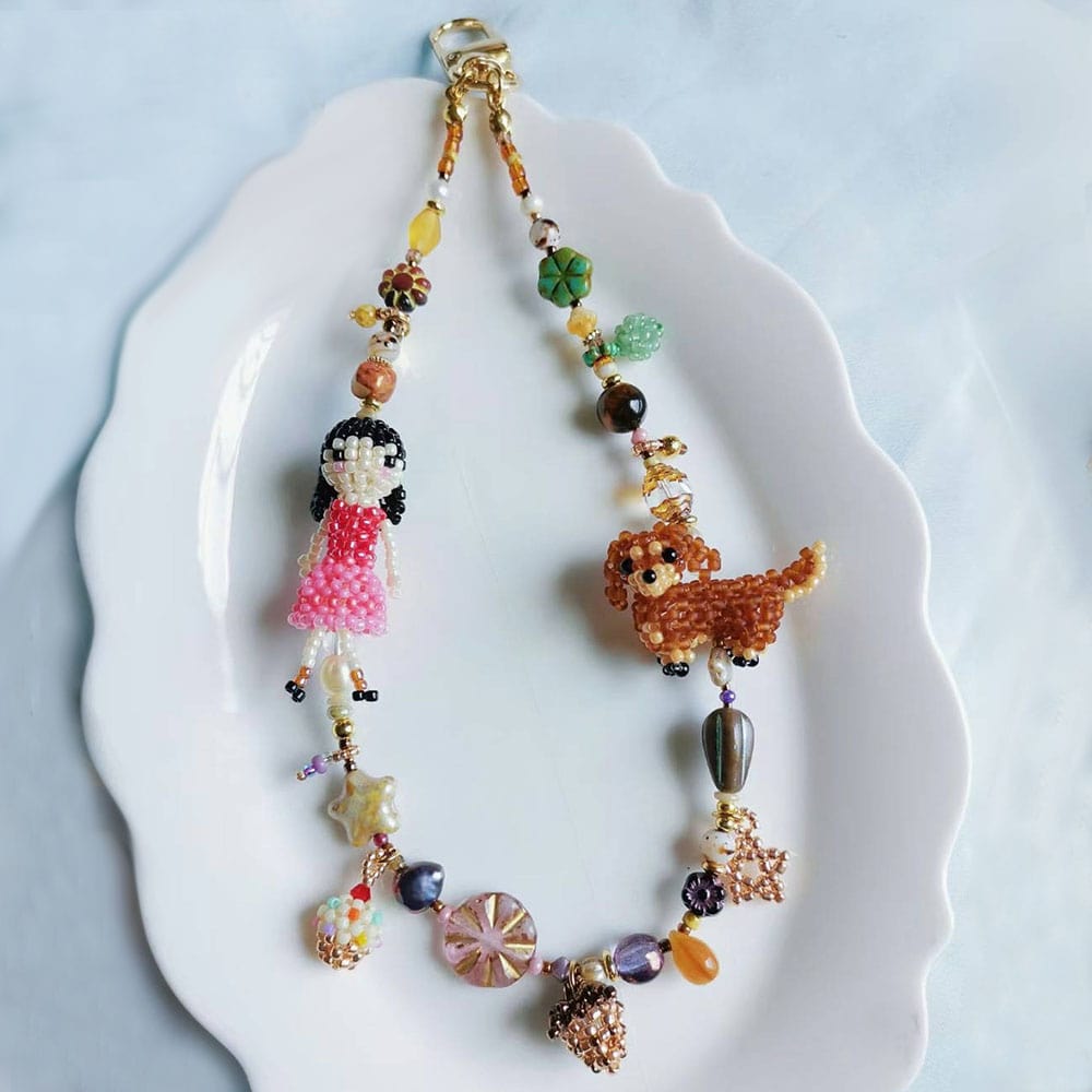 Colorful beaded bag charm with a little girl and her dachshund dog on a white plate - Verhalo custom jewelry