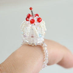 Beaded cake ring with red beads on a light background