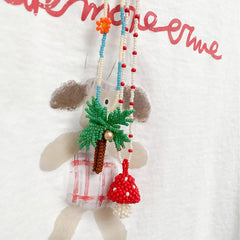 mushroom necklace and coconut tree necklace on a white background.