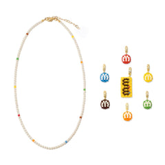 Colorful necklace and M&M's charm set on a white background