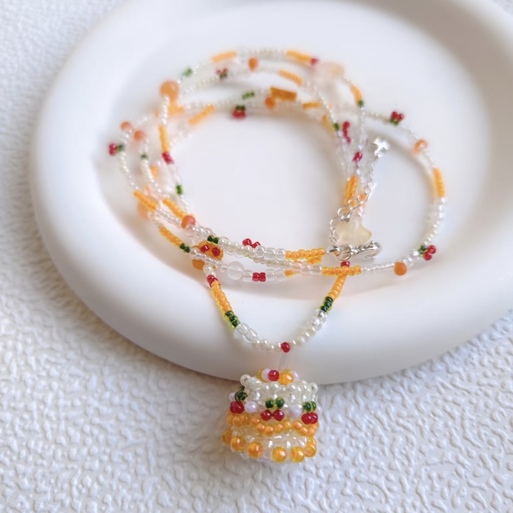 Beaded cake necklace with colorful beads on a white surface