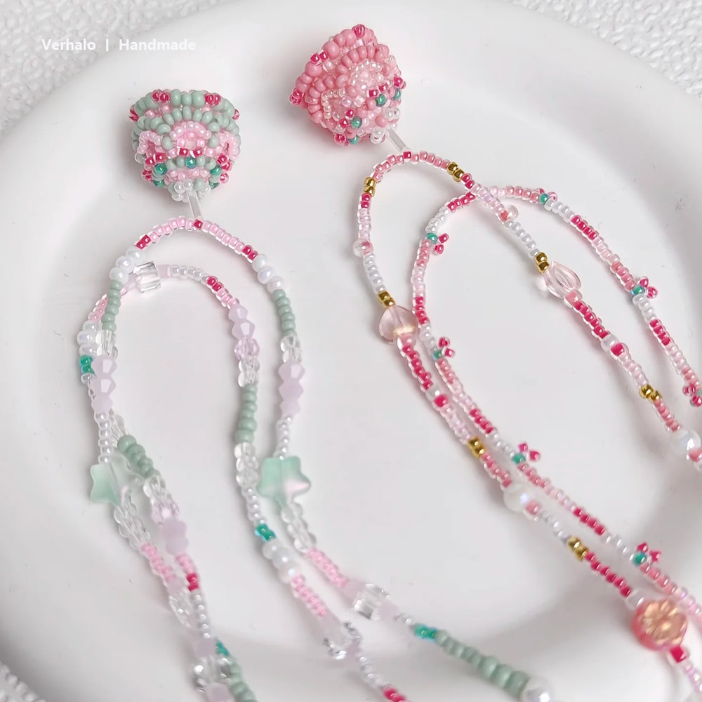 Beaded necklace  with pink and green beads on a white surface