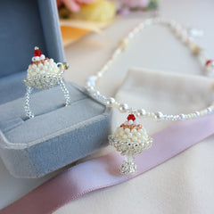 Pearl necklace with a decorative pendant on a light surface