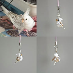Phone charm shaped like a parrot with a real parrot in the background