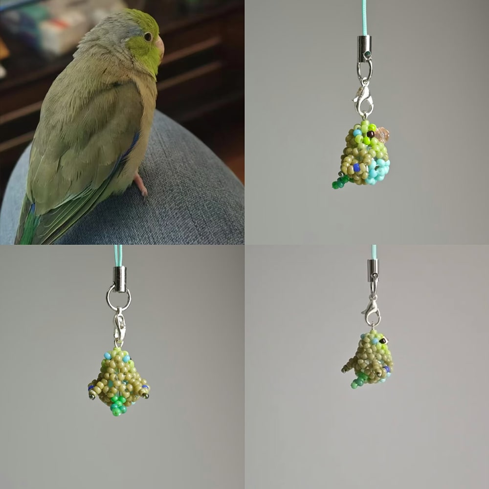 Green parakeet perched on a person's knee with two green beaded charms on gray backgrounds.