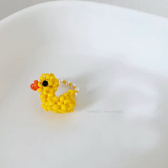 Yellow beaded duck ring on a white background
